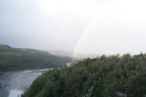 Double rainbow after rain over rocks and the Teriberka River, Murmansk region, Russia