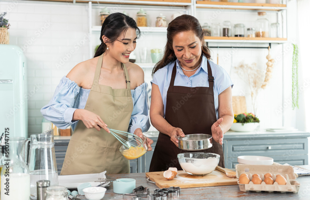 Happy Asian family making preparation dough and bake cookies in kitchen at home. Enjoy family activity together. Happy Asian family making preparation dough and bake cookies in kitchen at home. Enjoy family activity together.