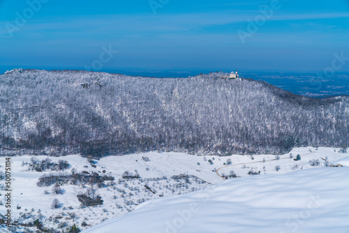 Germany, Castle teck on swabian alb mountain teckberg covered by snow in winter wonderland nature landscape scene, magical panorama view on sunny day
