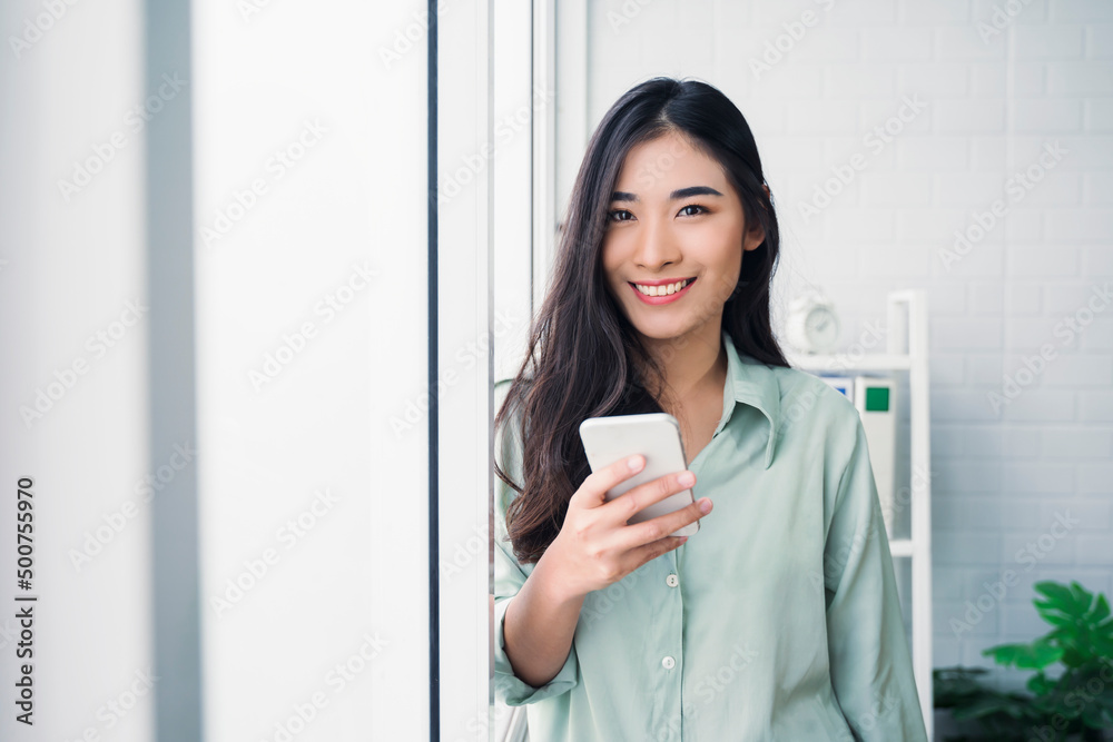 Beautiful Asian business woman work at home modern office, contacting mobile smartphone cheerful in success happy joyful, smart plan strategies using computer internet networking connection technology Beautiful Asian business woman work at home modern office, contacting mobile smartphone cheerful in success happy joyful, smart plan strategies using computer internet networking connection technology