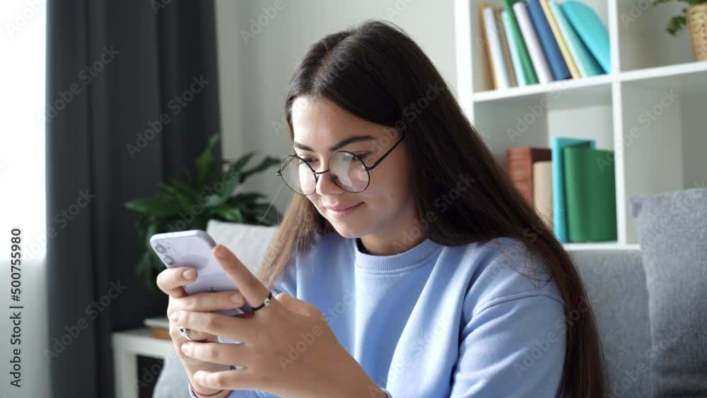 Cute teenage girl school pupil holding mobile phone. Teenager's hands typing, scrolling, searching browsing chatting send sms, studying at home. Social media concept. 4k footage Cute teenage girl school pupil holding mobile phone. Teenager's hands typing, scrolling, searching browsing chatting send sms, studying at home. Social media concept. 4k footage