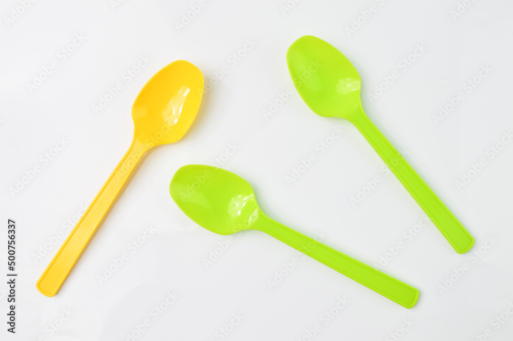 Yellow and green spoon isolated on a white background Yellow and green spoon isolated on a white background