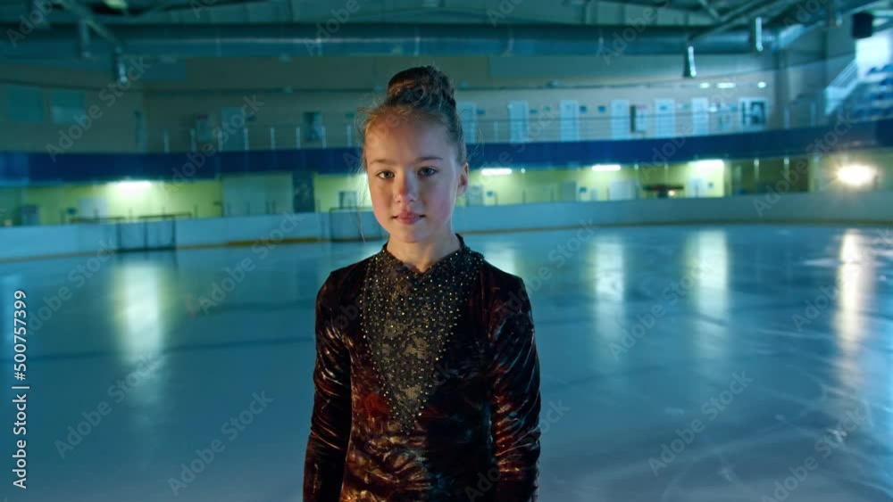 young woman figure skater is engaged in figure skating on ice. she makes different movements and pirouettes. training choreography at the rink before the start of the competition. Technology concept young woman figure skater is engaged in figure skating on ice. she makes different movements and pirouettes. training choreography at the rink before the start of the competition. Technology concept