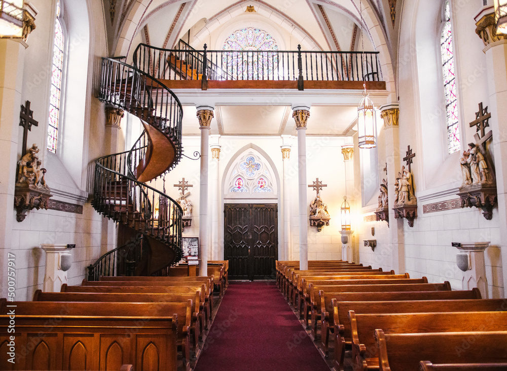 Naklejka premium Interior of Loretto Chapel in Santa Fe, New Mexico, and the miraculous helix staircase.