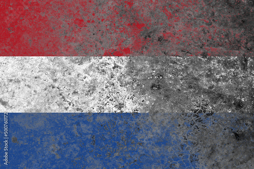 Netherlands flag on a damaged old concrete wall surface
