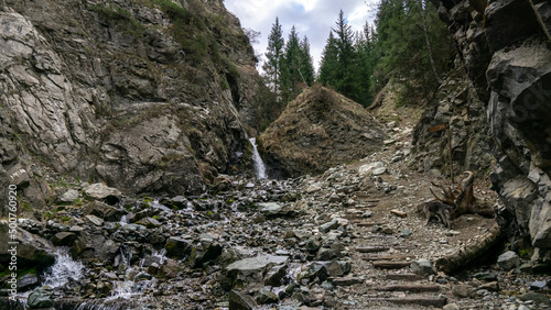 Mountain waterfall among the rocks photo