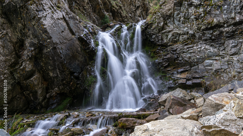 Mountain waterfall among the rocks