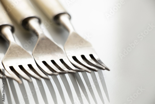 Old forks on a white background close-up, kitchen utensils, cutlery