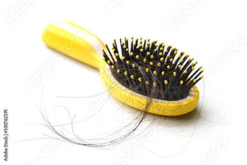 Comb with hair loss caused by stress or health problems  isolated photo on a white background.