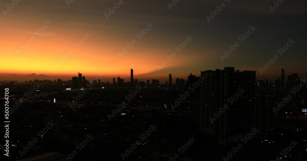 High-angle 4K video that sees condominiums of various sizes encircling the city center, business district, and blurry lights and passing cars during the evening twilight sky. High-angle 4K video that sees condominiums of various sizes encircling the city center, business district, and blurry lights and passing cars during the evening twilight sky.