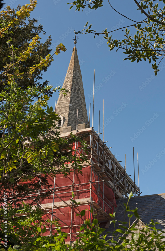 Bigbury, Devon, England, UK. 2022. Scaffolding and netting covering a church tower. Steeple that has been grouted. Bigbury, Devon, England, UK. 2022. Scaffolding and netting covering a church tower. Steeple that has been grouted.