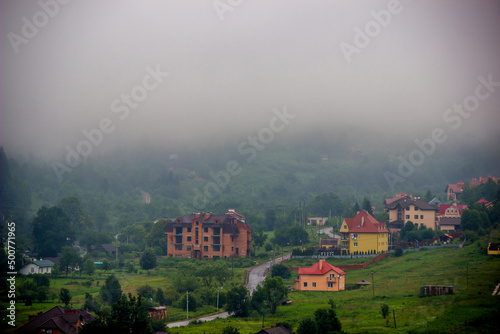 houses in the valley in the Ukrainian Carpathians at foggy weather