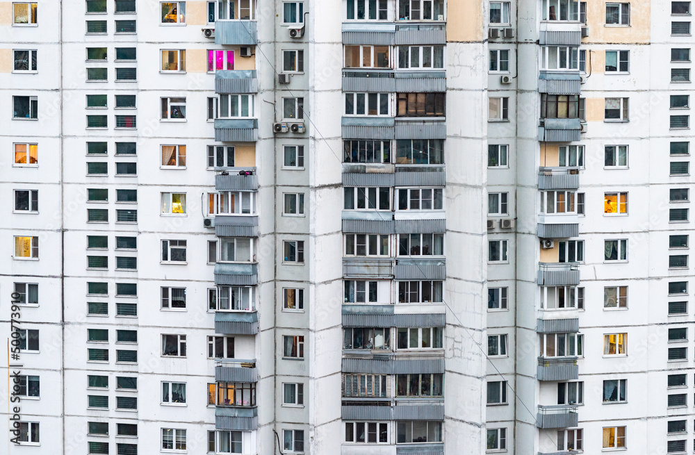 Windows of multi-storey panel residential buildings in a residential area of a large city. Windows of multi-storey panel residential buildings in a residential area of a large city.