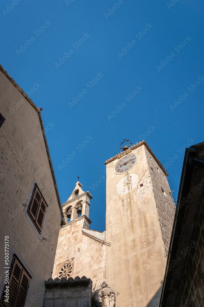 Clock tower and bell tower of the church of Saint Rocco in the old town of Omis, Croatia