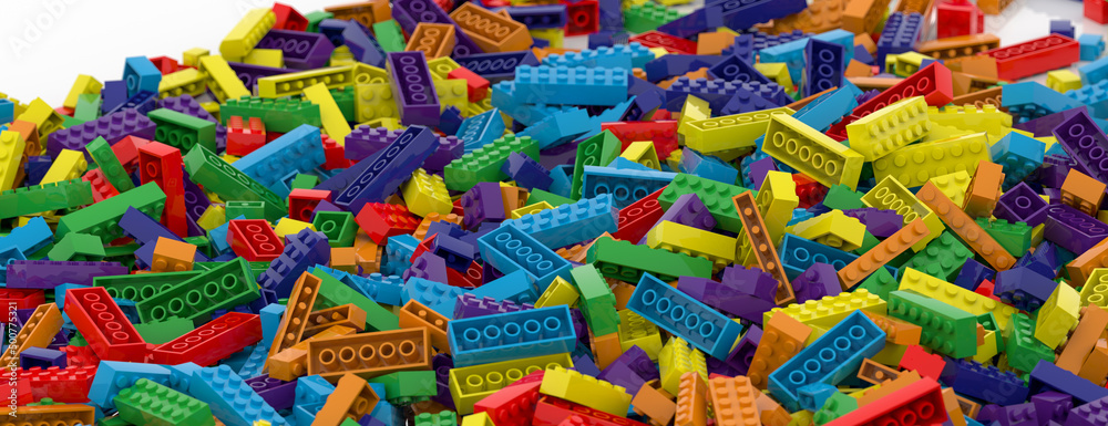 Colored toy bricks background. Rainbow colors. Random coloured plastic construction blocks. 3d illustration