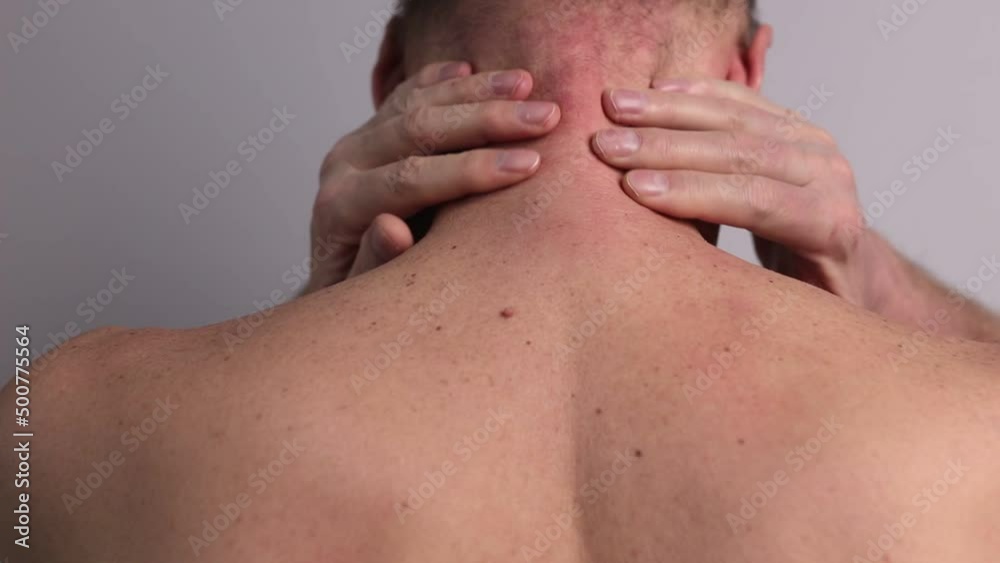 Neck pain or injury. Man hands massaging neck closeup. Health problems caused by incorrect posture, pinched nerve, muscle spasm concept. Neck pain or injury. Man hands massaging neck closeup. Health problems caused by incorrect posture, pinched nerve, muscle spasm concept.