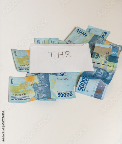 Indonesian money IDR in the envelope with THR text. THR is holiday allowance in iedul fitri or lebaran photo