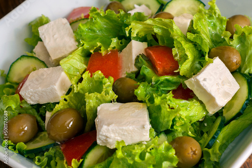 Greek salad with fresh vegetables, feta cheese, black olives and rusks.