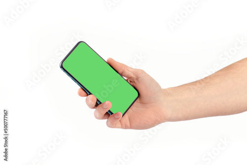 Male hand holding smartphone with green screen, isolate.