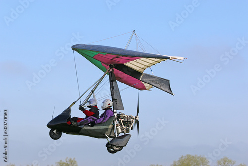 Ultralight airplane flying in a blue sky 