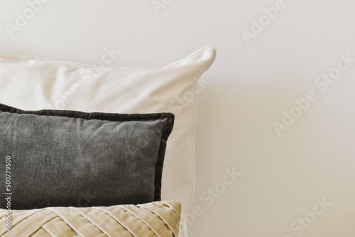 Bed with cushions against wall photo