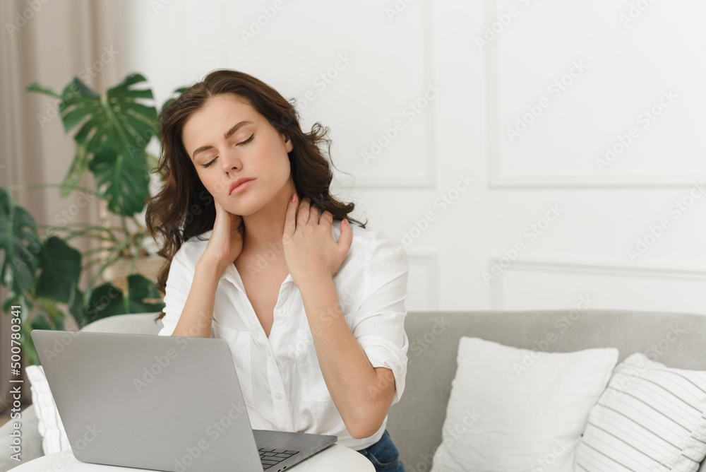Young female freelancer working from home and experiencing neck pain. Lots of work from home Young female freelancer working from home and experiencing neck pain. Lots of work from home