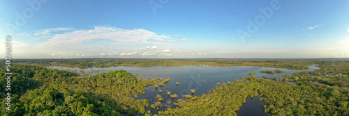 Amazonian national reserve Cuyabeno in Ecuador, wetland with lakes and ponds, river with piranas, dolphins, caymans, snakes and birds, aerial landscape view, green forest photo