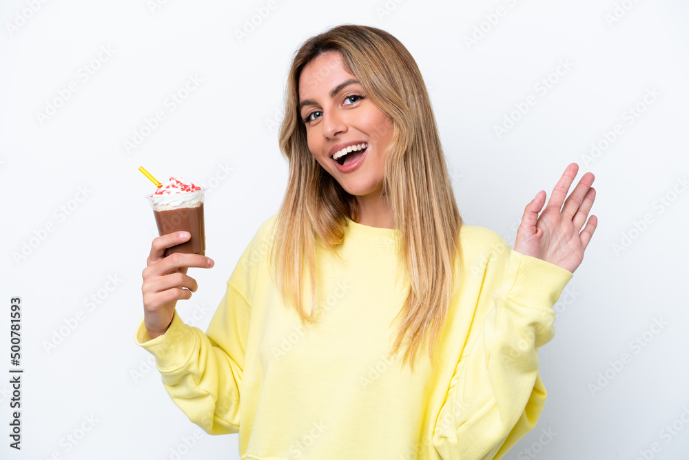 Young Uruguayan woman holding Frappuccino isolated on white background saluting with hand with happy expression Young Uruguayan woman holding Frappuccino isolated on white background saluting with hand with happy expression