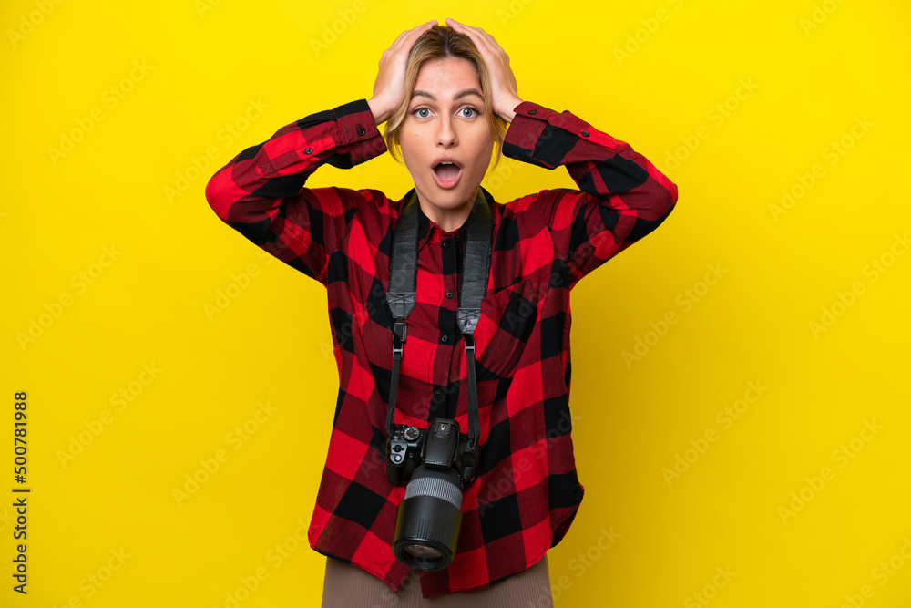 Uruguayan photographer woman isolated on yellow background with surprise expression Uruguayan photographer woman isolated on yellow background with surprise expression