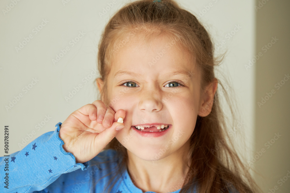 Toothless child. Cute little girl smiles broadly. The first milk tooth fell out. The concept of pediatric dentistry and dental hygiene Toothless child. Cute little girl smiles broadly. The first milk tooth fell out. The concept of pediatric dentistry and dental hygiene