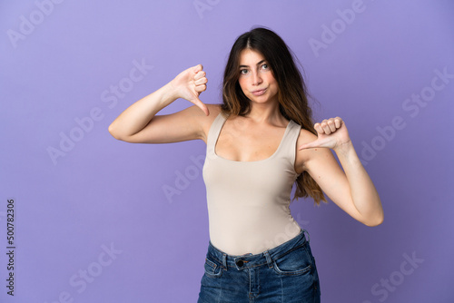 Young caucasian woman isolated on purple background proud and self-satisfied © luismolinero