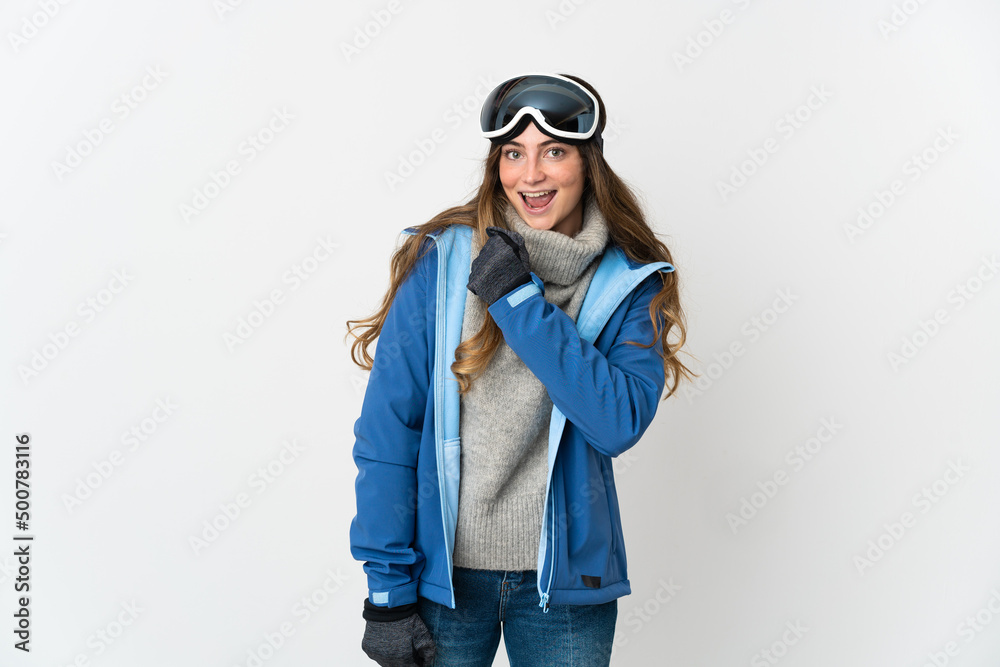Skier girl with snowboarding glasses isolated on white background celebrating a victory Skier girl with snowboarding glasses isolated on white background celebrating a victory