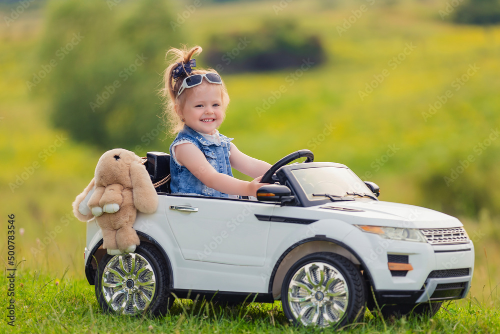 child rides in his car in nature child rides in his car in nature