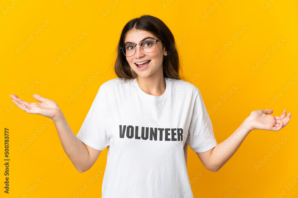 Young volunteer woman isolated on yellow background with shocked facial expression Young volunteer woman isolated on yellow background with shocked facial expression
