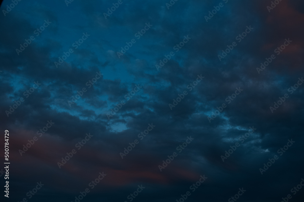 Natural landscape of dark cloudy sky at sunset.