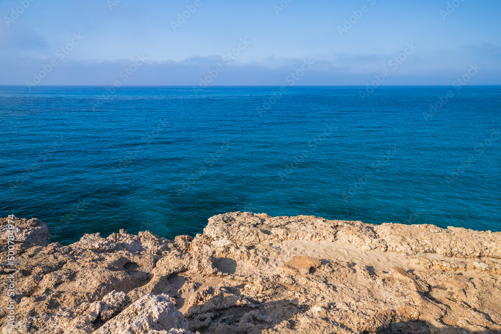 Rocky coast of Cyprus island on a sunny day. Mediterranean Sea