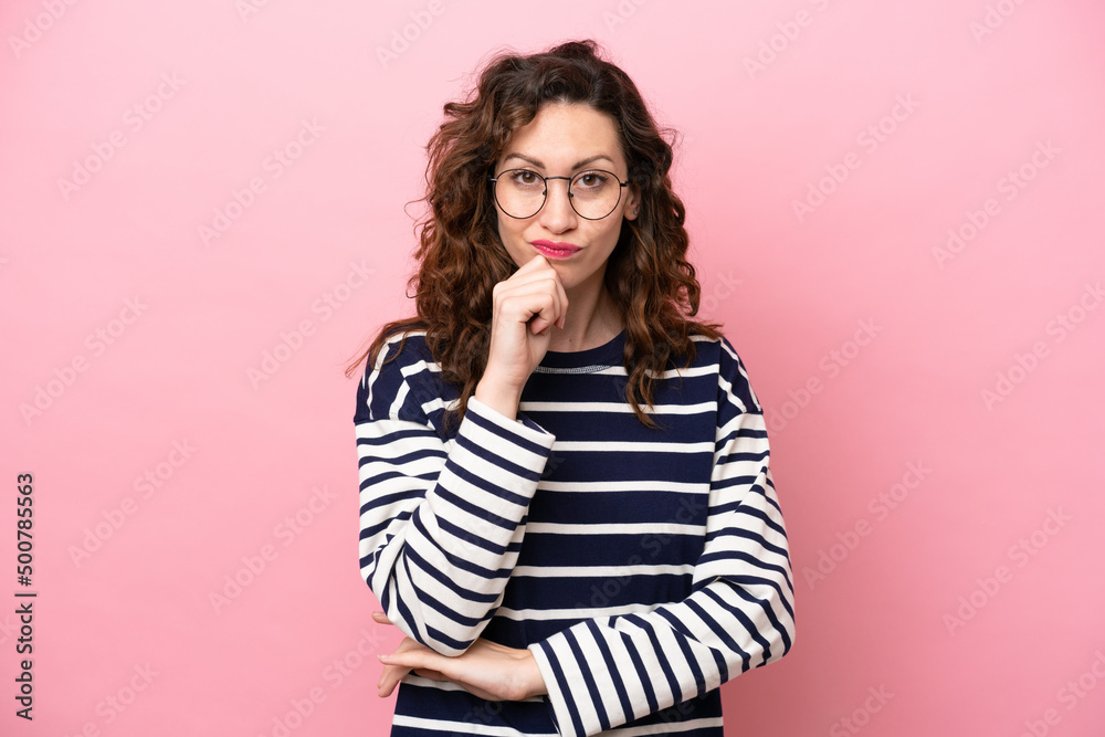 Young caucasian woman isolated on pink background having doubts and thinking Young caucasian woman isolated on pink background having doubts and thinking