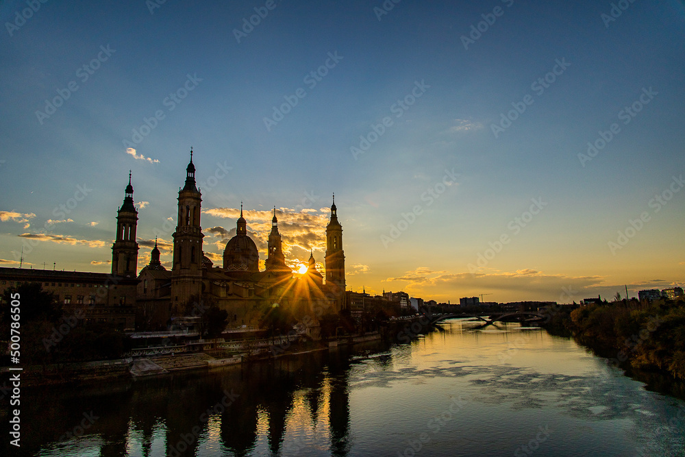  urban sunset over the Pilar cathedral in Zaragoza, spain and the Ebro river