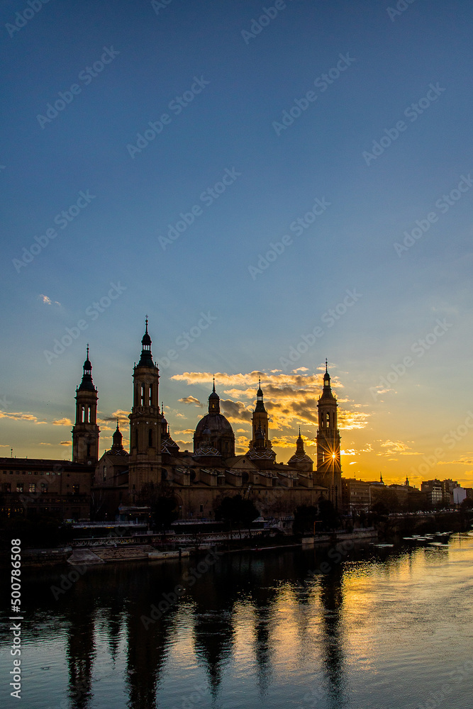 urban sunset over the Pilar cathedral in Zaragoza, spain and the Ebro river