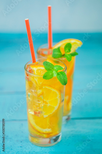 delicious refreshing cocktail drink with alcohol and orange with mint leaf