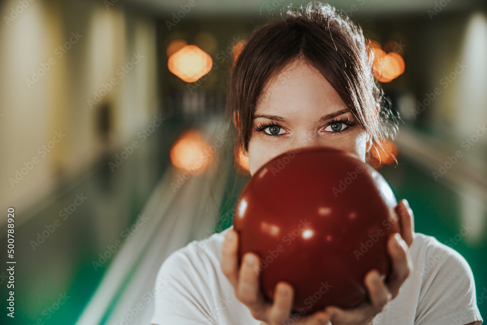 Young Woman Having Fun In A Bowling Alley - obrazy, fototapety, plakaty 