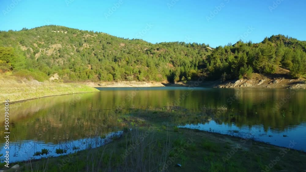 Blue lake in the Troodos mountains in the rays of the sun in the spring .Cyprus island. Aerial view. Blue lake in the Troodos mountains in the rays of the sun in the spring .Cyprus island. Aerial view.