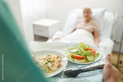 Medical worker walking with two plates of food