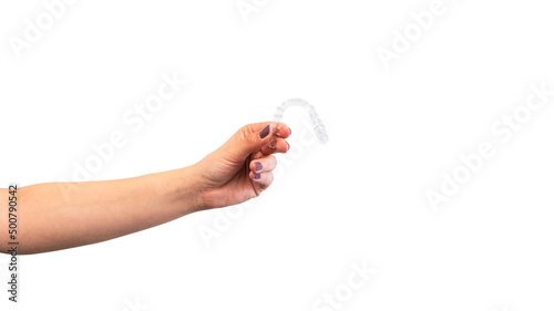 Adult woman holds invisalign transparent braces for dental correction.