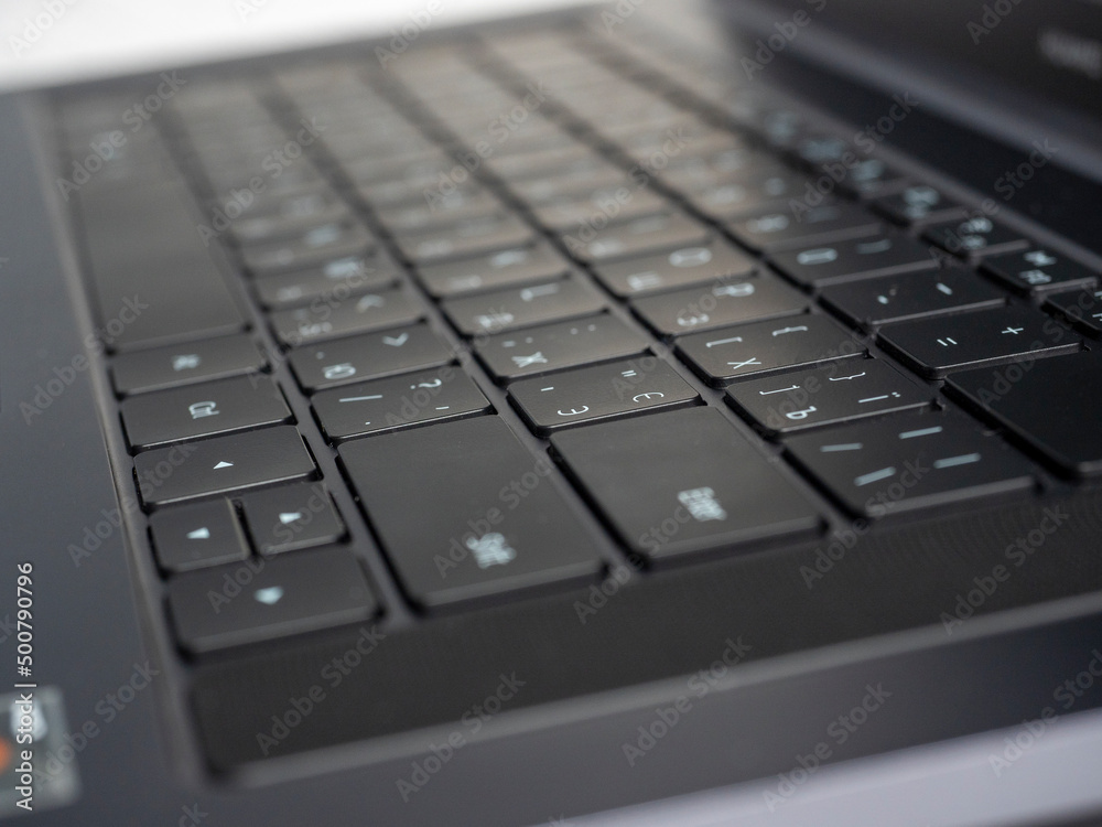 Close-up of the keyboard of an open laptop. Selective focus. Modern devices for work and leisure