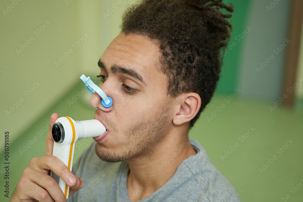 Male holding spirometer mouthpiece in his mouth Stock Photo Adobe Stock