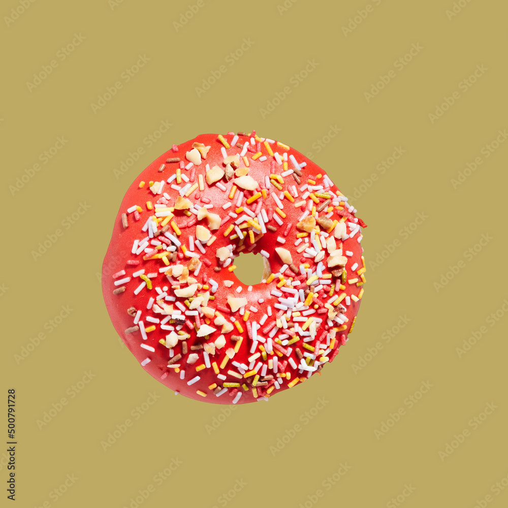 Red donut on yellow pastel background Red donut on yellow pastel background