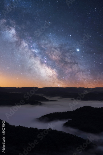 Milkway galaxy rising up over a fog filled valley in the Appalachian Mountains of Kentucky photo