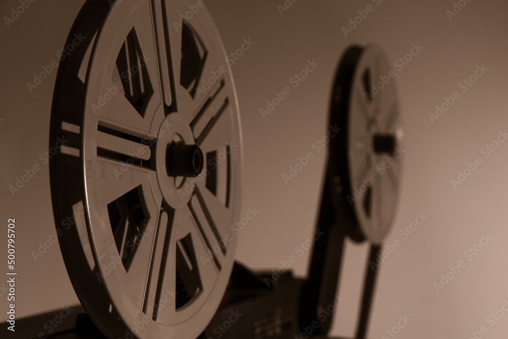Old vintage 8mm projector with film reels and film frames. Copy space. Selective focus.