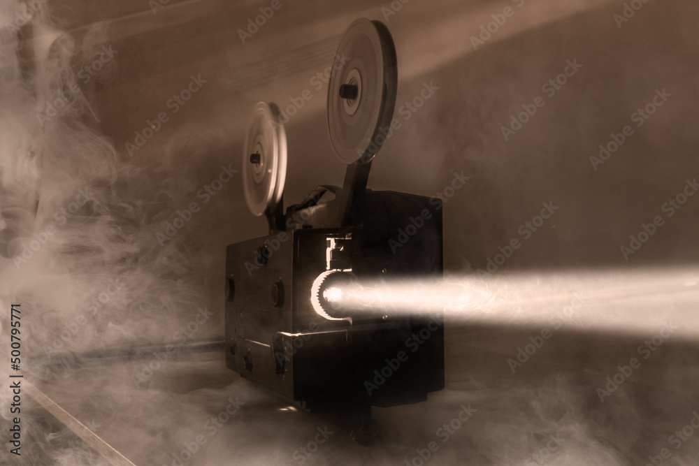 Fototapeta premium Old vintage 8mm projector with film reels and film frames. Copy space. Selective focus.